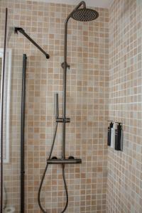 a shower with a shower head in a bathroom at Hostal La Torre Ibiza Cap Negret in San Antonio
