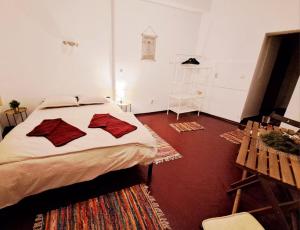 a bedroom with a bed with two pillows on it at Studio Piata Amzei in Bucharest