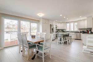a kitchen with a table and chairs in a kitchen at Seaside Solstice HOT TUB, SAUNA 4 Bedroom in Scituate