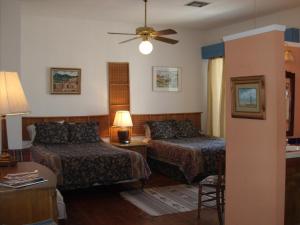 a hotel room with two beds and a couch at Lundeen Inn of the Arts in Las Cruces