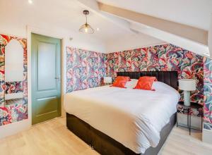 a bedroom with a large bed with colorful wallpaper at Betty's Spa Penthouse- 2bed Luxury Appt, Parking in Harrogate