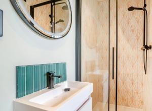 a bathroom with a sink and a shower at Betty's Spa Penthouse- 2bed Luxury Appt, Parking in Harrogate +7 photos