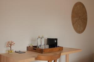 a wooden table with bottles on top of it at Hostal La Torre Ibiza Cap Negret in San Antonio