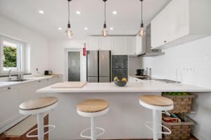 a kitchen with a counter and two stools in it at Cascais Villa - private pool in Cascais