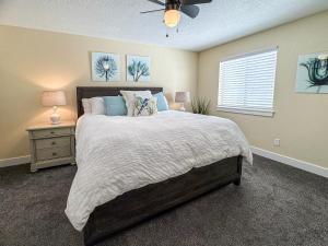 a bedroom with a large bed and a window at Bear Lake Bungalow in Garden City +29 photos