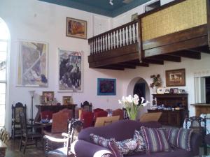 a living room with a couch and a staircase at Lundeen Inn of the Arts in Las Cruces
