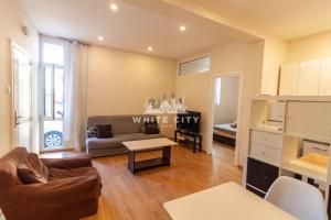 a living room with a couch and a table at TOWNHOUSE Apartments - Belgrade in Belgrade +1 photo