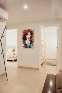 a white living room with a painting on the wall at Balili Home by the Sea in Ferrel