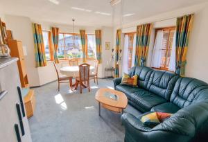 a living room with a couch and a table at Ferienwohnung Sonnenwinkl in Reit im Winkl
