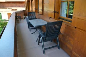 a table and chairs on the porch of a house at Ferienwohnung Sonnenwinkl in Reit im Winkl +7 photos