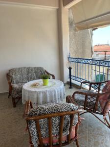 a living room with a table and chairs on a balcony at Seaside Apartment in Vergia in Vergia
