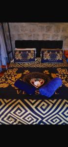 a bed with a blue comforter and a bowl on it at Minas Em Marambaia in Rio de Janeiro
