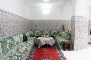 a living room with a couch and a table at Dar Al Hajja Fatima in Rabat