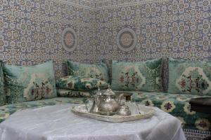 a living room with a couch with a tray of tea pots at Dar Al Hajja Fatima in Rabat +9 photos