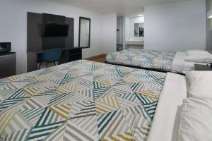 a hotel room with two beds and a television at Motel 6-Red Oak, TX - Dallas in Red Oak