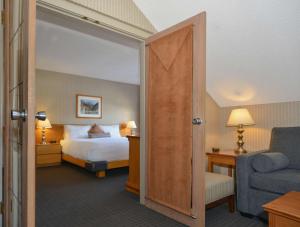 a hotel room with a bed and a chair at Listel Whistler, a Coast Hotel in Whistler