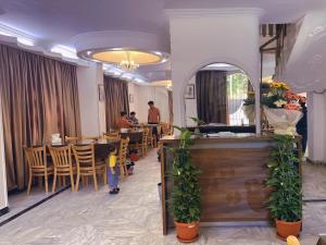 a restaurant with a child standing in front of a table at Xibei Lou Hotel 西北楼华人宾馆 in Cairo