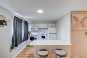 a kitchen with white cabinets and a counter with stools at Luxury Studio King Bed Chicago Remodeled in Chicago +1 photo