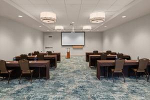 a conference room with tables and chairs and a screen at Homewood Suites by Hilton Anaheim Conv Ctr/Disneyland Main in Anaheim
