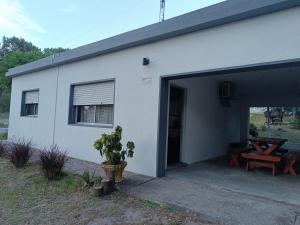 a white building with a large open garage at Mar dulce in Artilleros