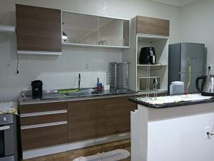 a kitchen with wooden cabinets and a sink in it at Holiday Home in Extremóz +9 photos