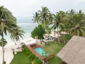 an aerial view of a resort with a swimming pool and the beach at The Point SurfHouse 3 meals included in Katiet