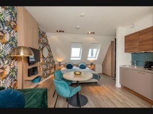 a room with a bed and a table and chairs at Romantic stay near Zoutelande in Zoutelande +61 photos