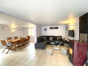 a living room with a couch and a table at Holiday Home in Kairon near the Beach in Saint-Pair-sur-Mer