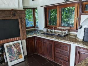 a kitchen with a sink and some windows at Casa Pura Vida in Punta del Este