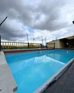 a large blue swimming pool on top of a building at Casa Guanentina - Habitaciones familiares in Villanueva
