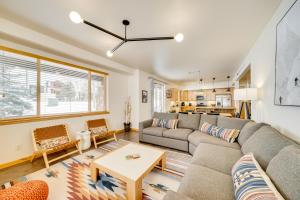 a living room with a couch and a table at Downtown WP Condo with Pool Steps to Concert Venue! in Winter Park