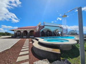 a building with a swimming pool next to a street light at Casona Cocobolo el mejor lugar de Costa Rica in Guanacaste