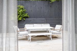 a patio with a table and chairs and a fence at Bella Boutique in Healesville