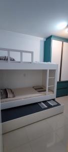 a white shelf in a room with some items at AP completo na Praia de Palmas, SC in Governador Celso Ramos