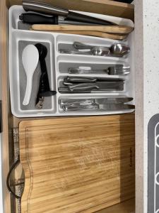 a drawer filled with knives and utensils in a kitchen at Luna y Sol Calle 8 in Miami