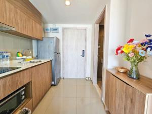 a kitchen with a vase of flowers on a counter at La Casita Condo Hua Hin 6 in Hua Hin