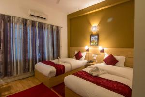 Letto o letti in una camera di Hotel Ananda Inn