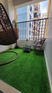 a balcony with a green floor and a table and chairs at Silver harbor apartments in Nairobi