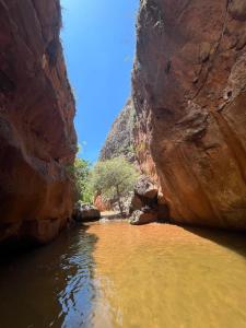 a river in the middle of a canyon at Paraíso no Velho Chico in Canindé de São Francisco +9 photos