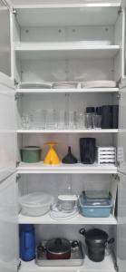 a refrigerator shelf filled with dishes and other items at Paraíso no Velho Chico in Canindé de São Francisco