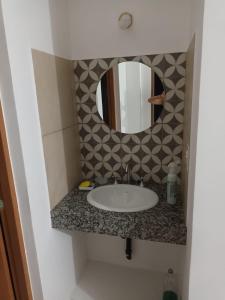 a bathroom with a sink and a mirror at Casa del Sol & Brasa Jujuy - Hermoso Duplex con Pileta y Asador in Alto La Viña