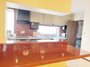 a large kitchen with a wooden counter top at 颯House 4 in Osaka