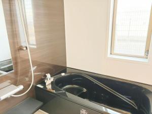 a bathroom with a black sink and a window at 颯House 4 in Osaka