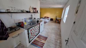 a kitchen with a sink and a counter top at Casinha Laranja in Rio de Janeiro