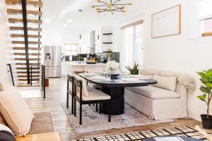 a kitchen and living room with a table and a couch at Lux Newly Remodeled DT, Patio, Fully Stocked 5Bd, 3Ba in Denver +28 photos