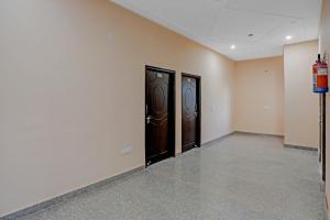two doors in a room with white walls at Hotel O AKKI RESIDENCY in Noida