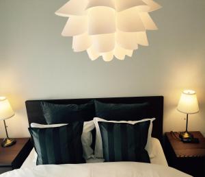 a bedroom with a bed with a chandelier above it at Apartment in Narita 225 in Narita