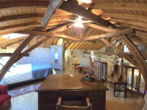 a bedroom with a bed and a desk in a room at Maison de charme à Brantôme, animaux admis, parking inclus - FR-1-616-461 in Brantôme