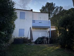 a white house with a garage in the yard at Confort Famille dans Résidence avec Piscine - FR-1-778-39 in Dolus-d'Oléron
