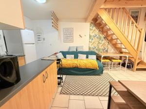 a kitchen with a bed in the middle of a room at Confort Famille dans Résidence avec Piscine - FR-1-778-39 in Dolus-d'Oléron